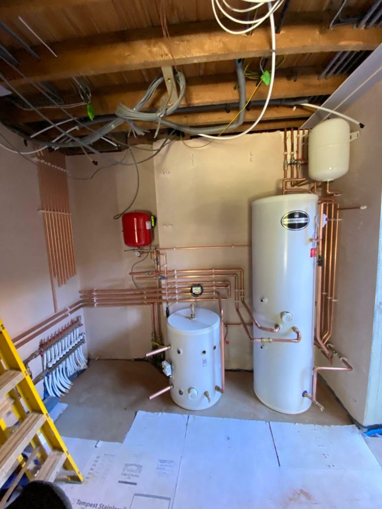 Professional boiler installation in progress, performed by certified engineers in Acton